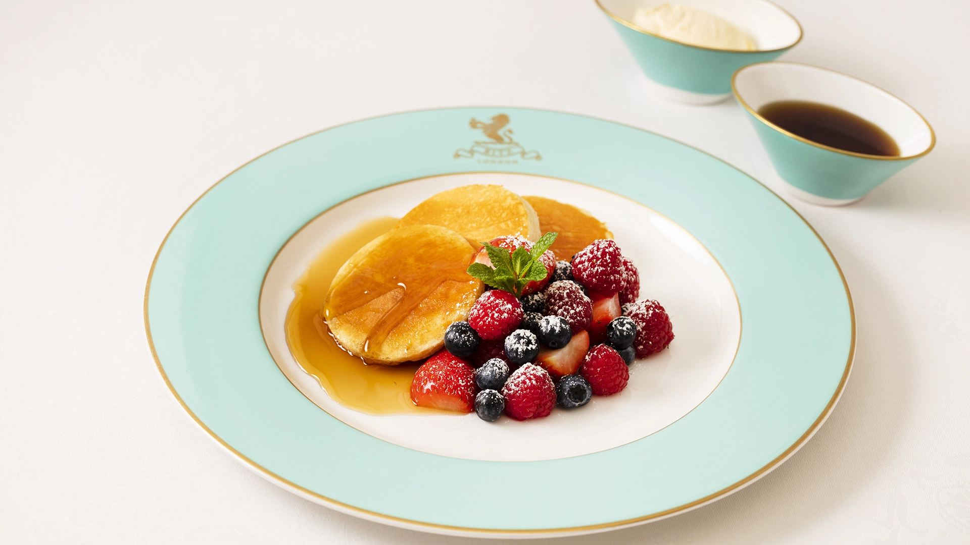 Ritz breakfast of pancakes and fruit in the Two Michelin Star Ritz Restaurant